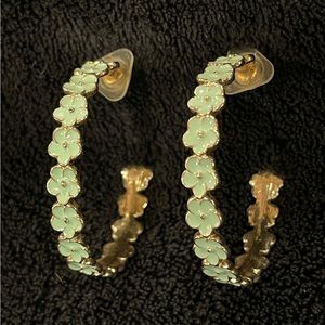 Adorable hoop earrings with celadon green enamel flowers.